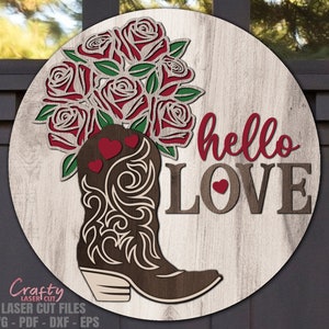 May include: A wooden round sign with a brown cowboy boot with red roses and hearts. The sign says "hello LOVE" in red and brown lettering.
