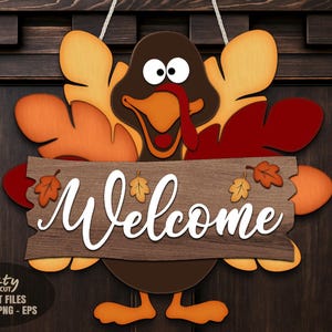 May include: A wooden turkey-shaped welcome sign with a brown body, orange and red feathers, and a wooden sign that says "Welcome". The sign is decorated with fall leaves and is hanging on a dark brown door.