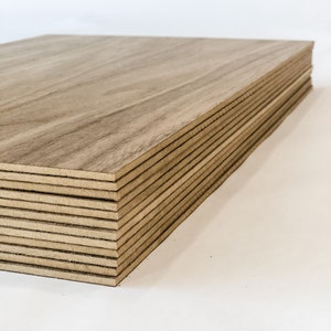 May include: A stack of light brown wood panels, likely plywood, with a wood grain pattern. The panels are stacked neatly and are ready for use in a variety of woodworking projects.