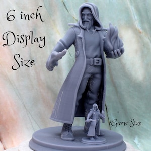 May include: A 6 inch tall gray 3D printed miniature of a wizard holding a flame, next to a smaller game-sized version of the same miniature. The text "6 inch Display Size" and "Game Size" are visible in the image.
