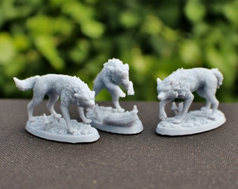 May include: Three grey painted miniature wolf figurines on circular bases. The wolves are in different poses, one is standing, one is running, and one is snarling.