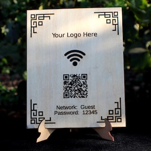 May include: A wooden sign with a decorative border and a wifi symbol. The sign also includes a QR code and the text "Your Logo Here", "Network: Guest", and "Password: 12345".