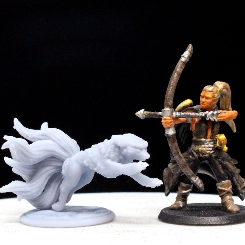 A gray 9-tailed fox miniature and a painted miniature of a woman with a blond ponytail holding a bow.