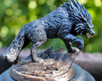 May include: A black wolf figurine with a spiky mane and glowing green eyes. The wolf is standing on a rocky base.