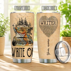May include: Two stainless steel tumblers with lids, featuring a tan parchment-style background. The front shows a vintage typewriter with a forest graphic and the text "WRITE ON". The back displays a heart-shaped word cloud with "WRITER" and "Your name".
