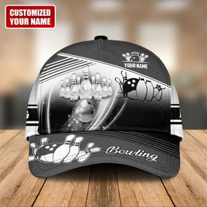 May include: A black and white baseball cap with a bowling theme. The cap features bowling pins, a bowling ball, and the word "Bowling". The text "CUSTOMIZED YOUR NAME" is displayed on the front.