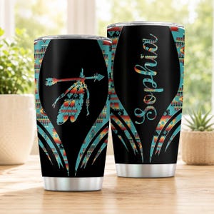 May include: Two stainless steel tumblers with a black background and a colorful geometric pattern. One tumbler features an arrow and feather graphic, while the other displays the name Sophia in a cursive script with a gradient color effect.