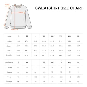 May include: A sweatshirt size chart featuring a line drawing of a crewneck sweatshirt with labels for sleeve length, 1/2 bust, and length. Two tables provide measurements in inches and centimeters for sizes S through 5XL, covering length, sleeve, bust, and shoulder.