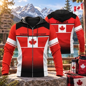 May include: A red, white, and black zip-up hoodie featuring a Canadian maple leaf design, the text "CANADA" and "YOUR NAME" on the front, and a matching back view. The hoodie includes a hood with drawstrings and a full-length front zipper closure.