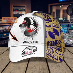 May include: A baseball cap featuring a white front panel with a graphic of a person DJing with vinyl records and the text YOUR NAME. The side panel is tan with a repeating pattern of headphones, speakers, and cassettes. The brim displays MUSIC ON WORLD OFF.