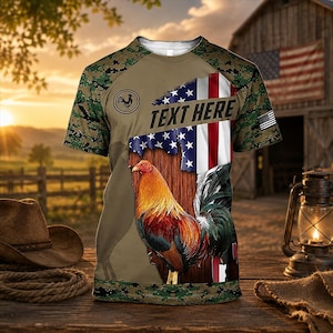 May include: A short-sleeve t-shirt featuring a camouflage pattern on the sleeves and hem, a central graphic of a rooster, and a vertical American flag design. The shirt includes a circular rooster logo and a text box with the words TEXT HERE.