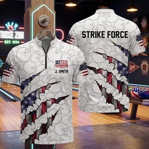 May include: A white quarter-zip polo shirt featuring a repeating bowling ball pattern, a torn-effect graphic revealing an American flag design, the text "STRIKE FORCE" on the back, and the text "J. SMITH" with a small flag graphic on the front.