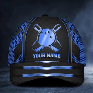 May include: A black and blue baseball cap with a bowling ball and pins design. The cap has a mesh back and a blue brim. The text "YOUR NAME" is printed on the front of the cap.