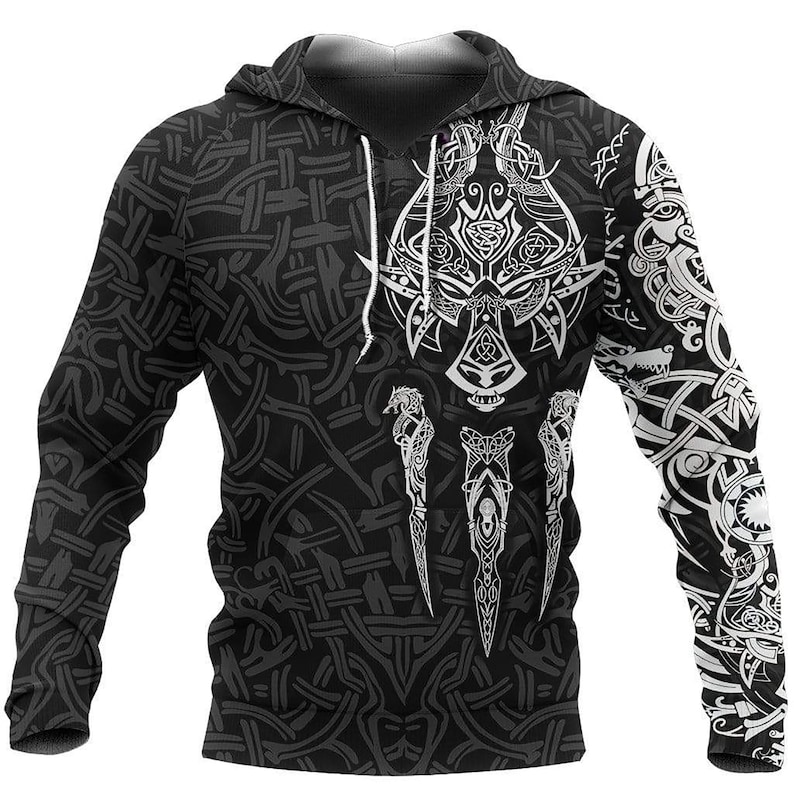 May include: A black long-sleeve hooded sweatshirt featuring a white intricate graphic print of a wolf head and stylized knotwork patterns across the front and sleeves. The garment includes a hood with white drawstrings and a repeating woven design.