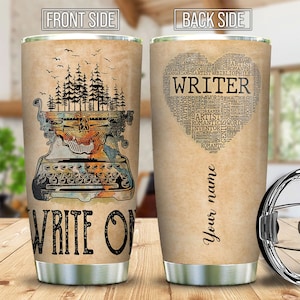 May include: A stainless steel tumbler with a vintage typewriter design and the words "Write On" on the front. The back of the tumbler features a heart-shaped word cloud with the word "Writer" in the center.