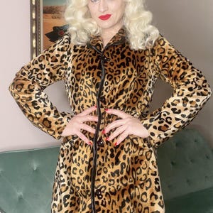 May include: A brown and black leopard print robe with a black satin trim and button closure.