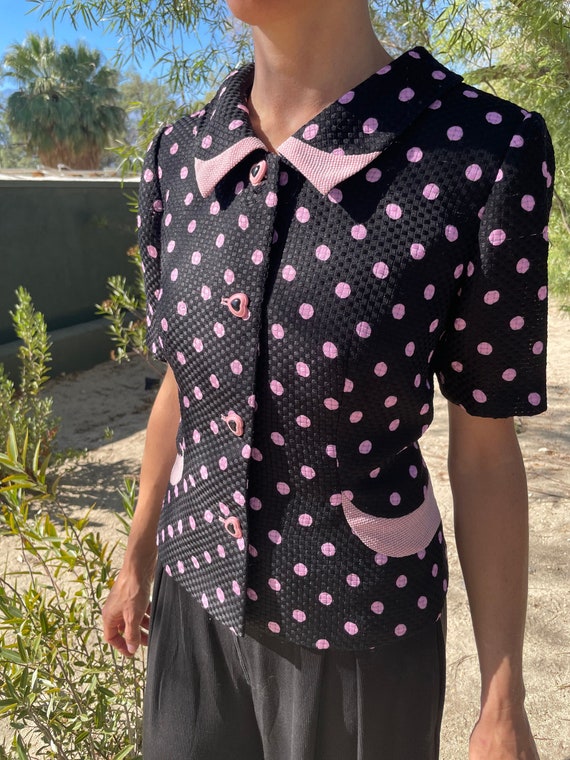 pink top with black polka dots
