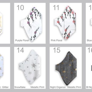 May include: Collection of face masks with various designs. Includes white masks with gold floral, purple floral, pink floral, and blue floral patterns. Other masks feature gold stars, snowflakes, and metallic prints. The last two masks have a night organza design.