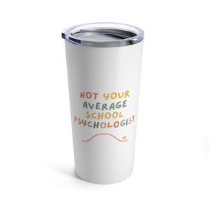 May include: White stainless steel tumbler with a blue lid. The tumbler has the text "NOT YOUR AVERAGE SCHOOL PSYCHOLOGIST" in colorful, handwritten font.