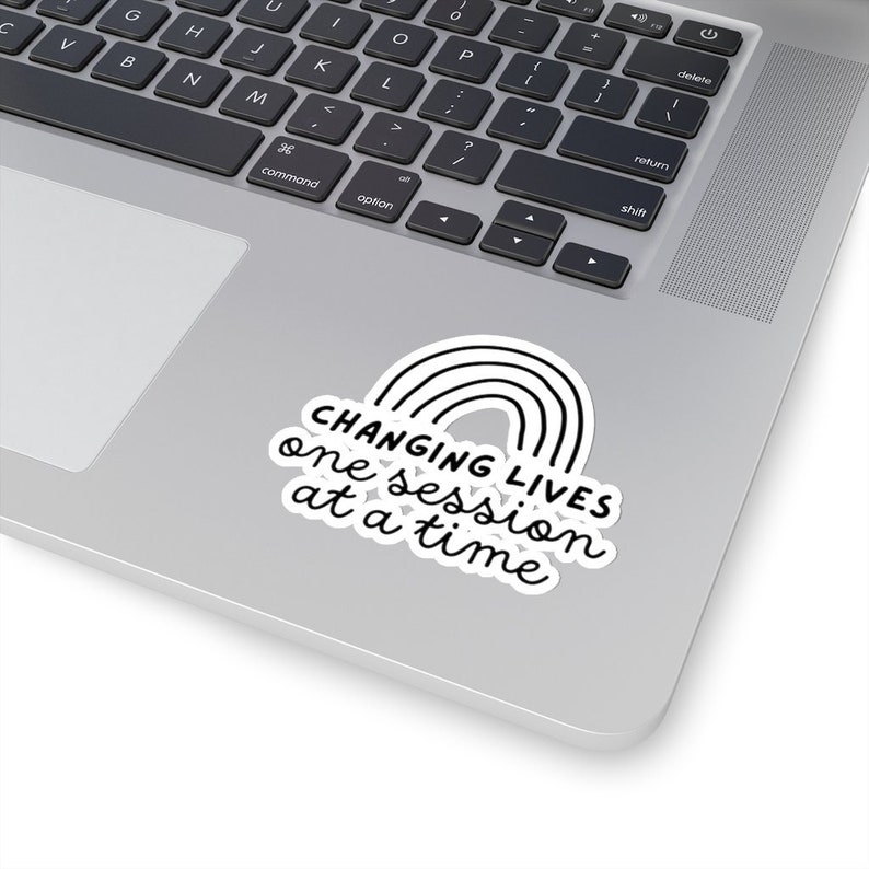 May include: A white sticker with a black rainbow and the text "CHANGING LIVES one session at a time".