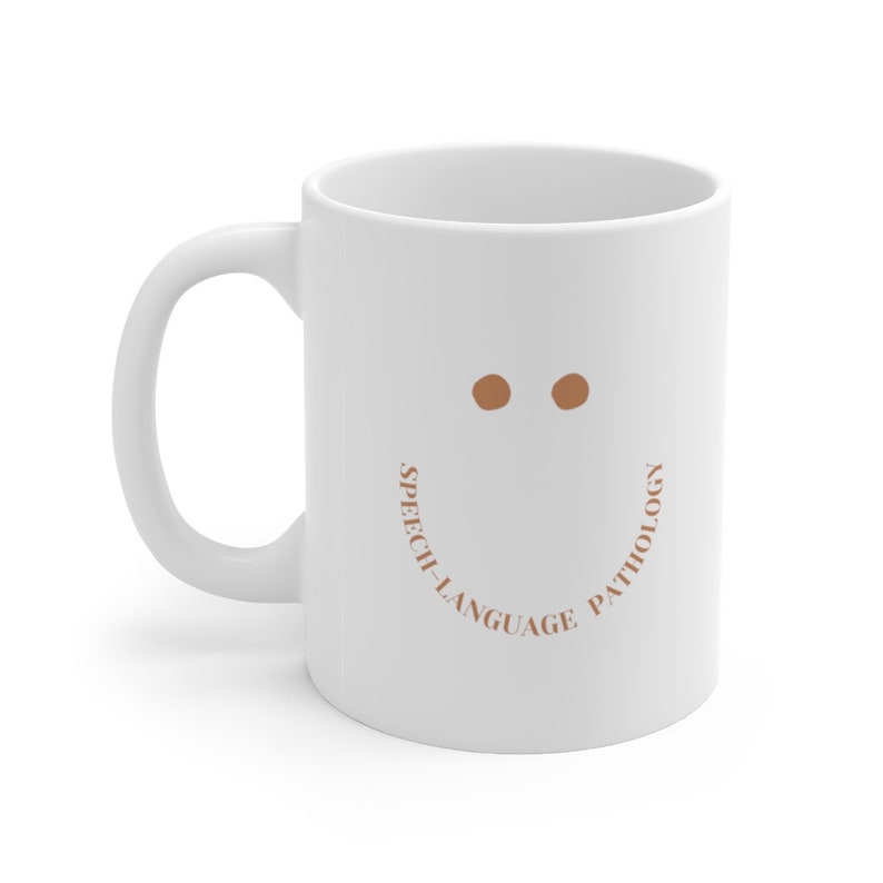 May include: White ceramic coffee mug with a brown smiley face and the text "Speech-Language Pathology" around the bottom of the mug.