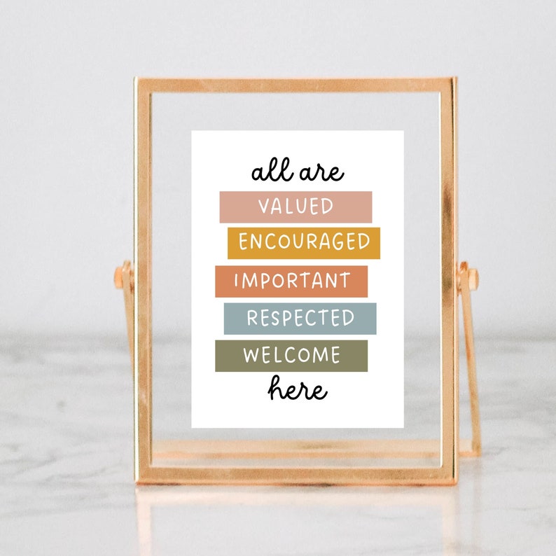 May include: A gold-framed print with the text "all are valued, encouraged, important, respected, welcome here" in black lettering on a white background. The words are arranged in a vertical stack with each word on a colored rectangle.