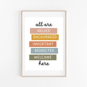 May include: A framed print with the text "all are valued encouraged important respected welcome here" in black lettering on a white background. The words are stacked vertically and each word is on a different colored rectangle. The colors are pink, yellow, orange, blue, and green.