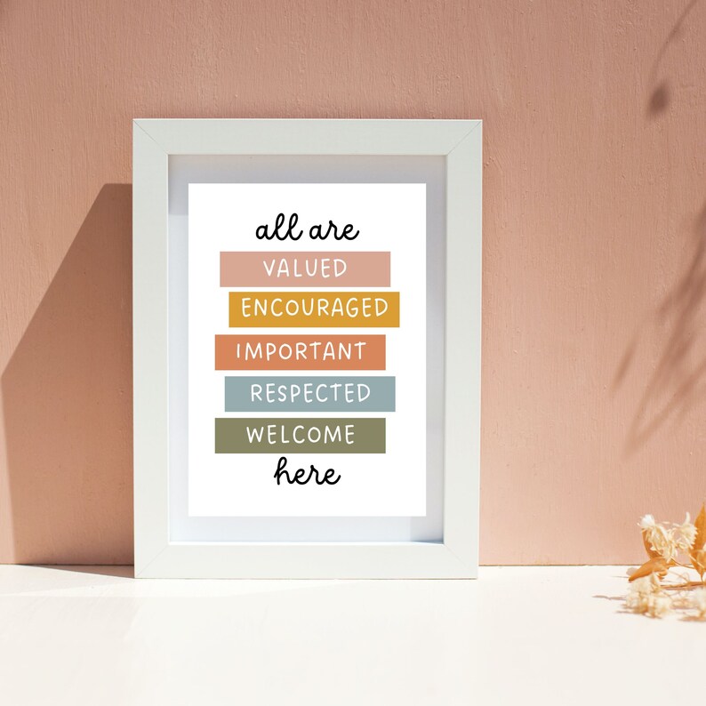 May include: White framed print with the text "all are valued encouraged important respected welcome here" in black lettering. Each word is on a separate colored rectangle. The colors are peach, yellow, light blue, green, and brown.