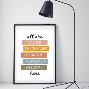 May include: A framed print with the text "all are valued encouraged important respected welcome here" in black lettering on a white background. The words are arranged in a vertical stack with each word on a different colored rectangle. The rectangles are in shades of pink, yellow, orange, blue, and green.