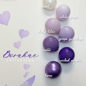 May include: A collection of purple, lilac, and white balloons with names like "pearl", "dusty lilac", "white grape", "grape gumdrop", "violet", "wicked purple", and "bora". The balloons are arranged in a gradient from white to purple. The text "POP FEST CO" and "Borahae collection" is also visible.