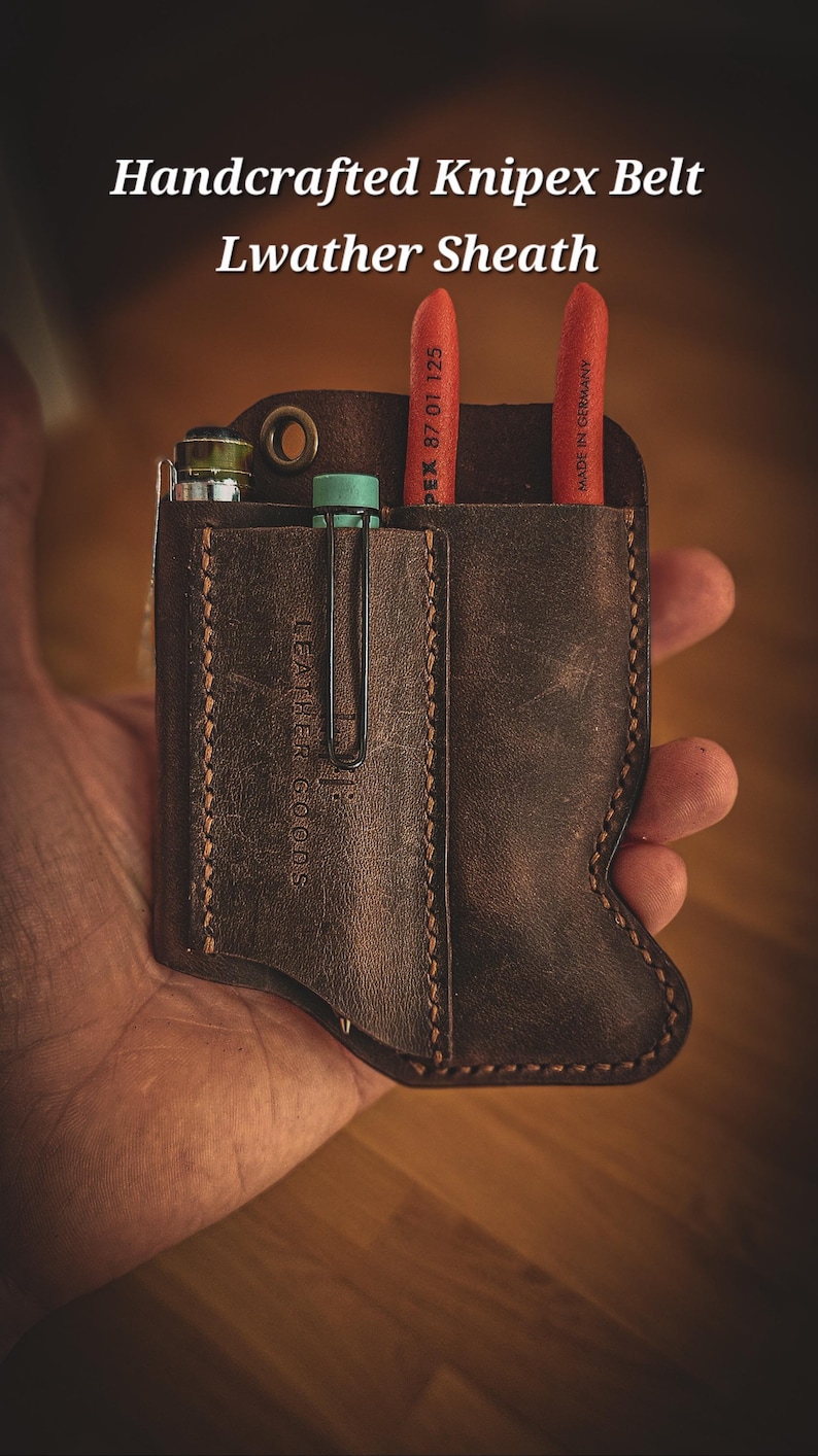 May include: Handmade brown leather belt sheath with the text "Handcrafted Knipex Belt Leather Sheath". The sheath holds tools, including red handled pliers and a small vial. The sheath is held in a hand.