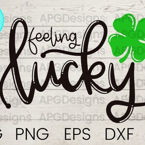 May include: Black and white cursive text that reads "feeling lucky" with a green four-leaf clover to the right of the text.