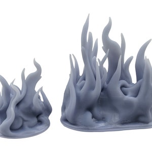 May include: Two grey, stylized flame sculptures. The flames have a flowing, organic shape, with pointed tips and a textured surface. One sculpture is smaller than the other. The sculptures are likely made of resin or a similar material.