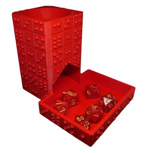 May include: Red dice tower with a removable tray. The tower has a textured surface and the tray has a textured surface. The tray has six red dice with gold numbers.