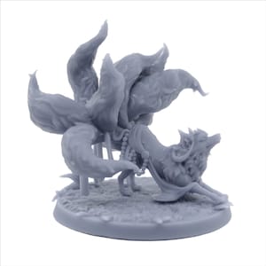 May include: A gray 3D printed figurine of a fox with nine tails. The fox is wearing a beaded necklace and a flowing robe. The figurine is standing on a round base.