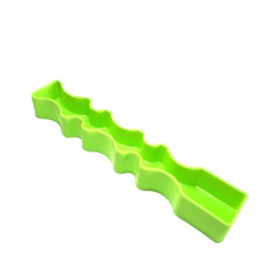 May include: A bright green plastic dish with a wavy, indented design. The dish is long and narrow, and it has a smooth, glossy finish.