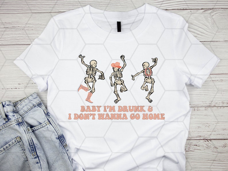 May include: White t-shirt with a graphic of three skeletons dancing. The skeletons are wearing cowboy hats and boots. The text "Baby I'm Drunk & I Don't Wanna Go Home" is printed below the skeletons.