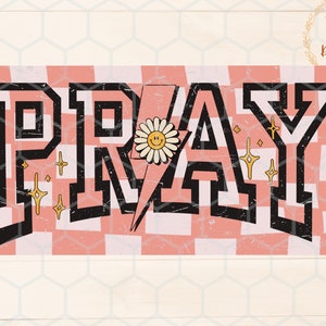 May include: A pink and white checkered background with the word "PRAY" in black block letters. A yellow daisy with a smiley face is in the centre of the "A".