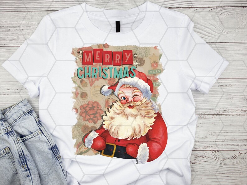 May include: White t-shirt with a vintage-style Christmas graphic featuring Santa Claus winking and the text "Merry Christmas".