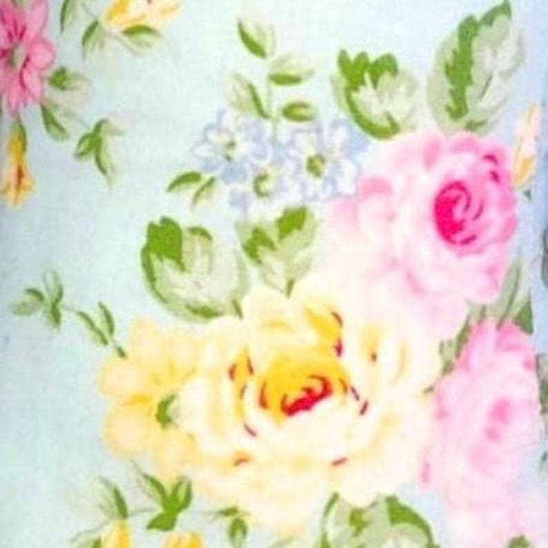 May include: A floral pattern featuring roses in shades of pink and yellow, with accents of blue and green leaves, set against a light blue background. The design has a watercolor effect, creating a soft, vintage aesthetic.