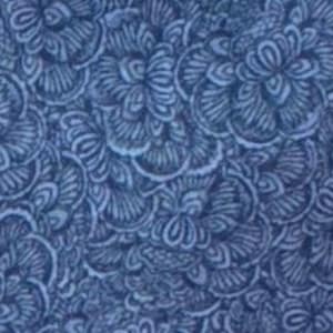 May include: A close-up of a fabric with a repeating floral pattern in shades of blue. The design features stylized, swirling flower-like shapes with intricate details, creating a textured appearance. The overall effect is a dense, all-over print.