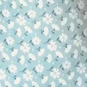 May include: A light blue fabric with a repeating pattern of white flowers and leaves. The flowers have multiple petals and are interspersed with smaller, fan-shaped elements. The background has small white dots.