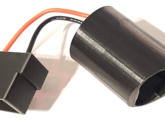 May include: A black electrical connector with two wires, one red and one black, attached to a black cylindrical battery holder.