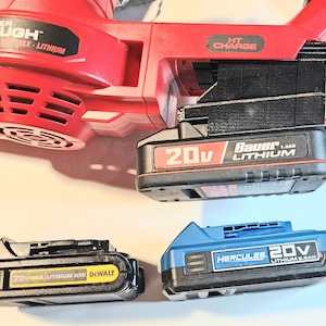 May include: A red and black power tool with the text "HYPER TOUGH" and "HT CHARGE". Three black and blue 20V lithium-ion batteries are shown, with the brands "Bauer", "Dewalt", and "Hercules".