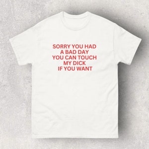 Könnte beinhalten: Ein weißes Kurzarm-T-Shirt mit rotem Text, der mittig auf der Brust steht: SORRY YOU HAD A BAD DAY YOU CAN TOUCH MY DICK IF YOU WANT. Das Kleidungsstück hat einen Rundhalsausschnitt und eine Standardpassform mit deutlich lesbaren Buchstaben.