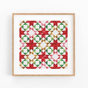 May include: A square cross stitch pattern featuring a repeating geometric star design in shades of red, green, and gold on a white background, displayed within a light-toned wooden frame. The pattern consists of small, pixelated squares.