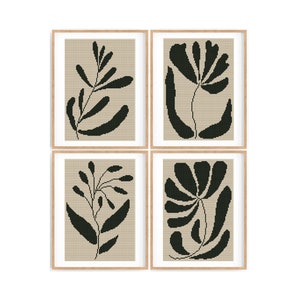 May include: Set of four framed prints with black and white abstract floral designs on a beige background.