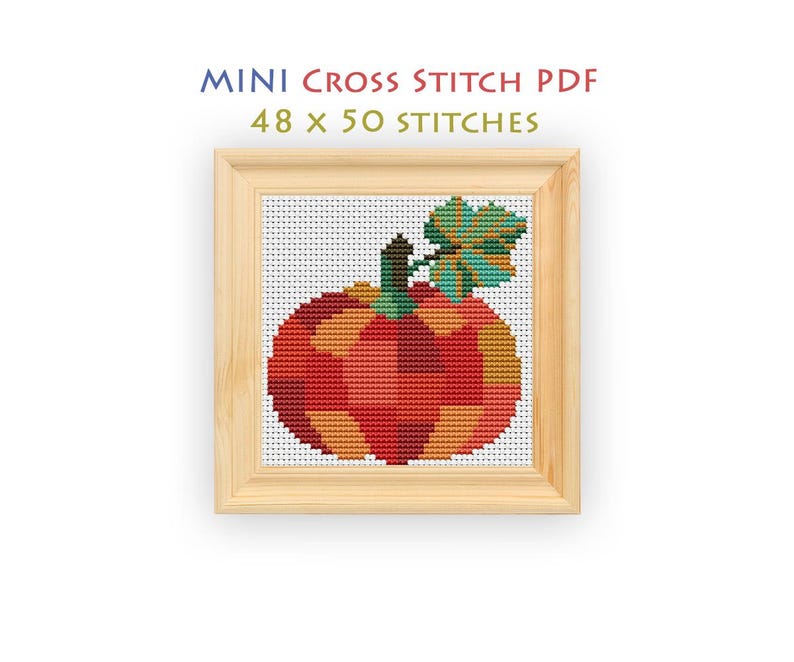 Pode incluir: Um padr&atilde;o de ponto cruz de uma ab&oacute;bora em tons de vermelho, laranja e amarelo com uma folha e caule verdes, emoldurado em madeira clara. O texto acima diz MINI CROSS STITCH PDF 48 x 50 STITCHES sobre um fundo de grade branca.
