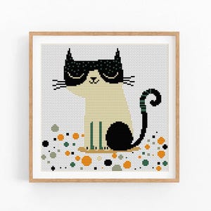 May include: Cross stitch pattern of a black and white cat wearing sunglasses and sitting on a bed of green, orange, and gray circles.