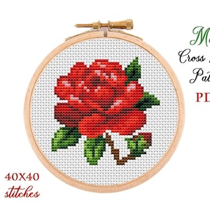 May include: A red rose cross stitch pattern in a wooden embroidery hoop. The pattern is 40x40 stitches and is available as a PDF download. Mini Cross Stitch Pattern PDF.